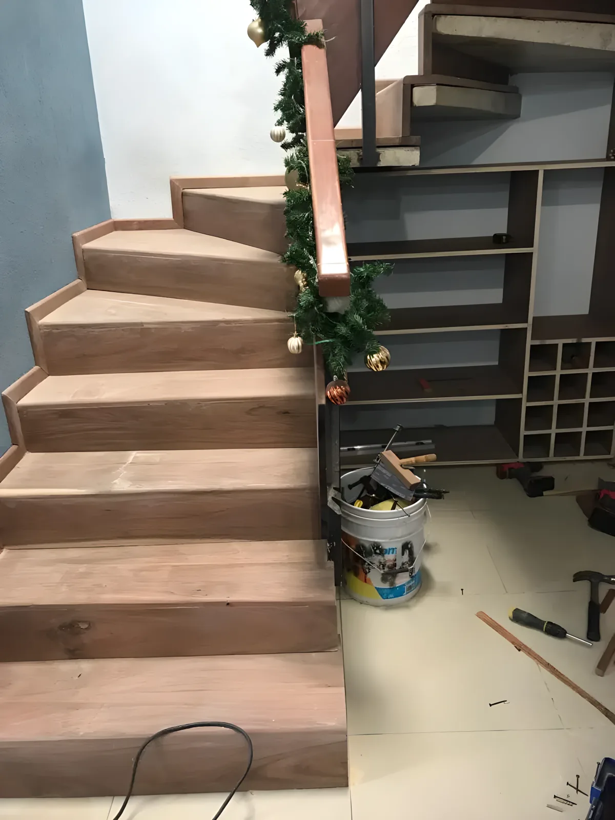 Wood staircase with wine cellar and shelves under treads