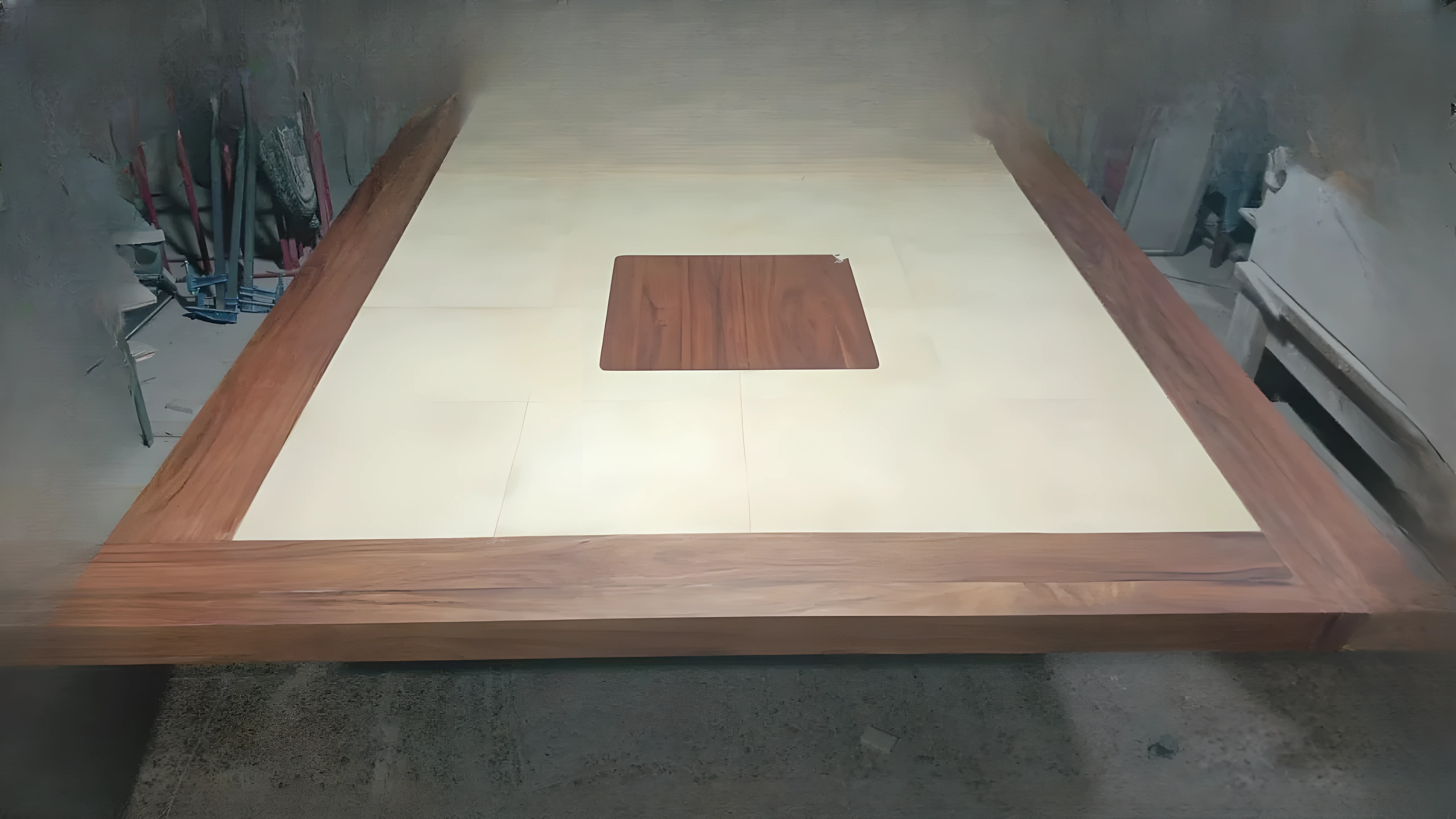 Craftsman applying shellac with pad on antique furniture restoration