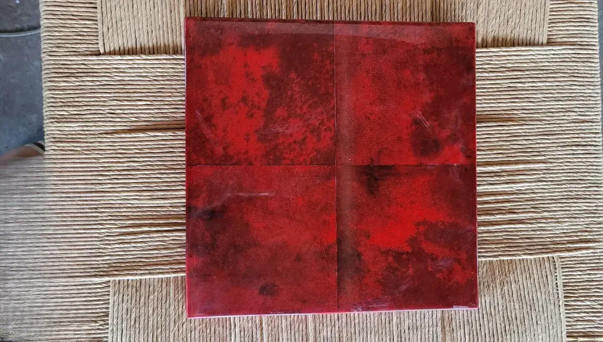 Intense ruby red parchment texture with visible natural grain, exotic finish