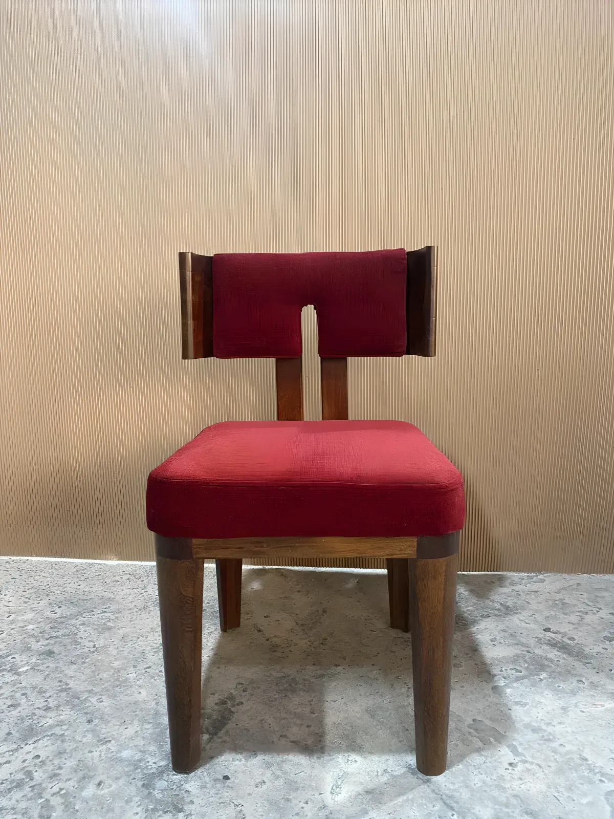 Walnut dining chair with ergonomic curved back and red upholstery, contemporary design